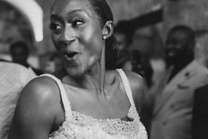 A joyful expression and laughter captured in black and white during a celebratory moment.