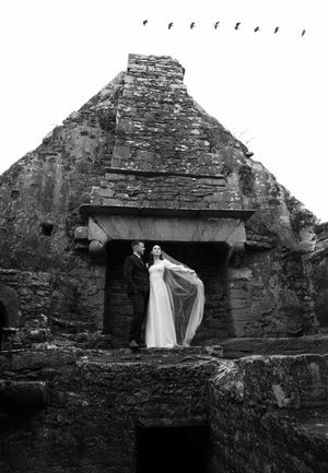Ethereal bridal portraits against weathered stone walls of an ancient Scottish ruin.