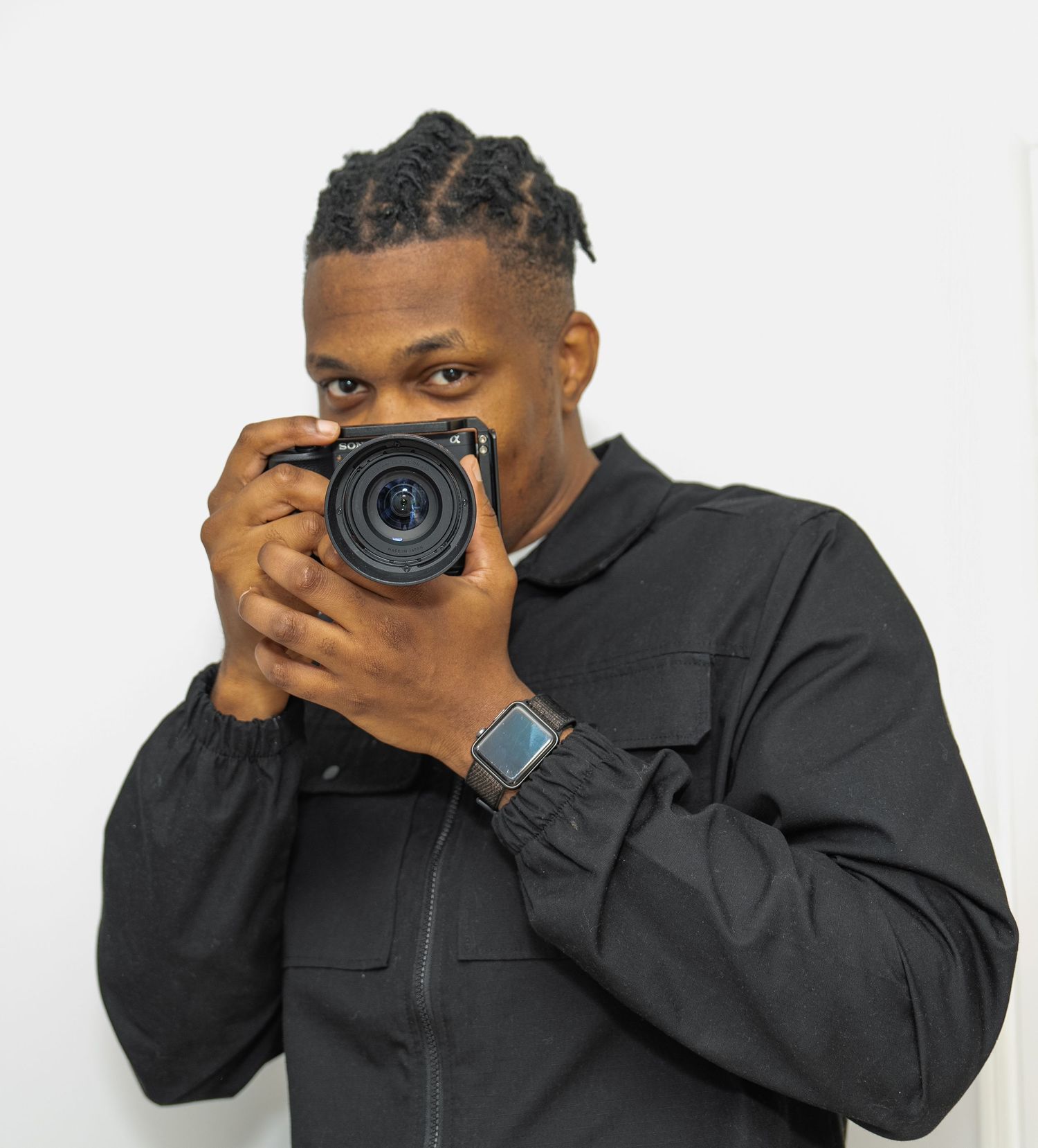 men with braids hold a camera