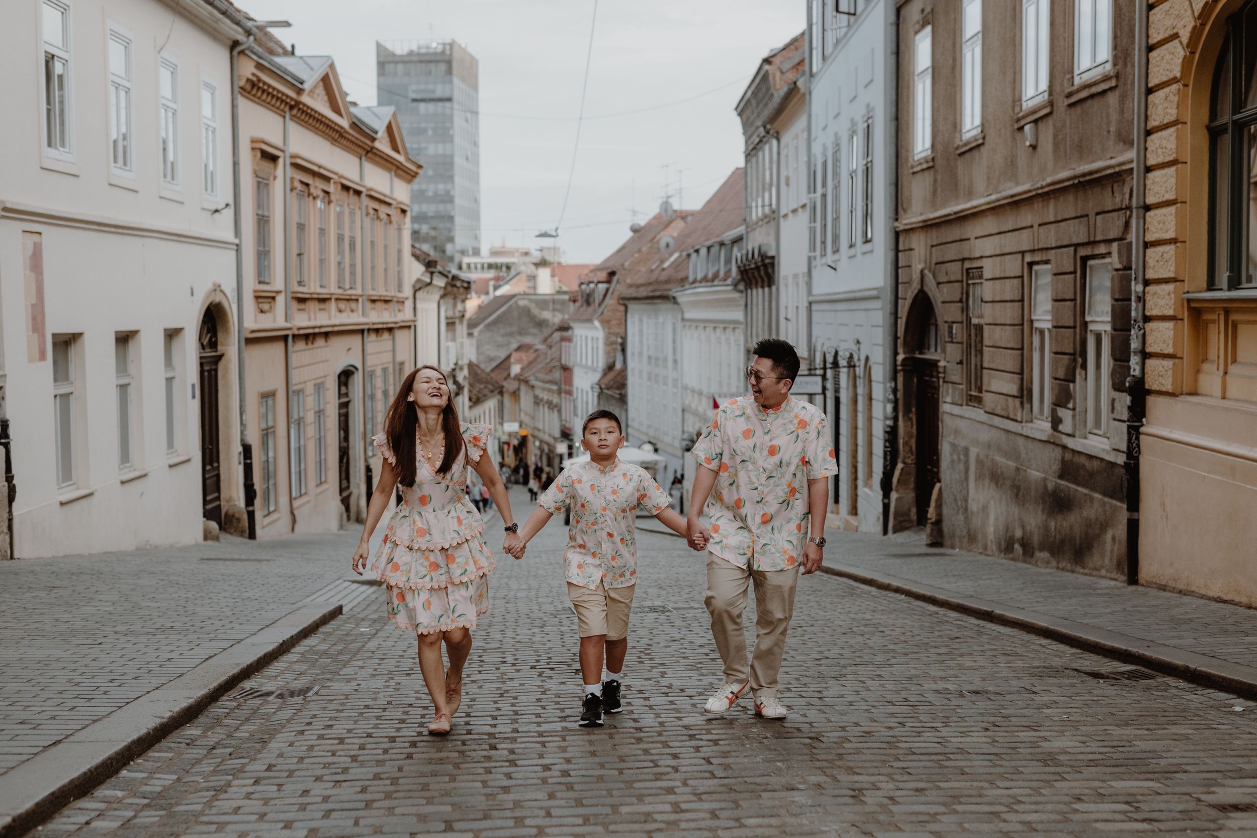 Parents and their 10-year-old gazing at the architecture of Zagreb’s Upper Town, sharing a moment of wonder.