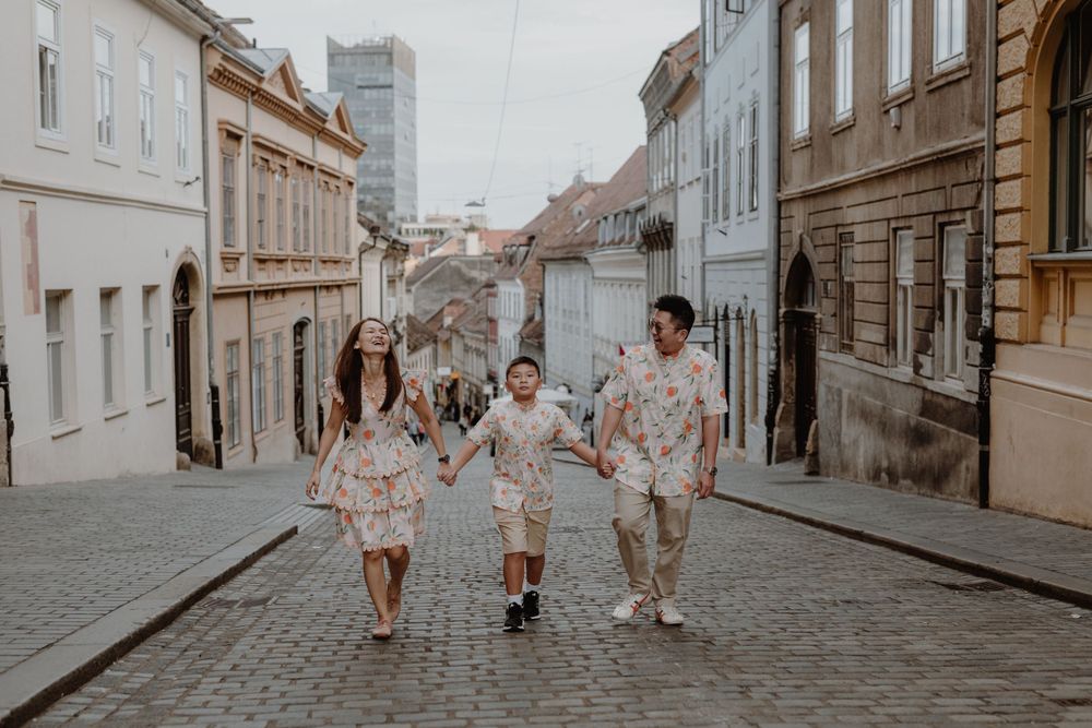 Parents and their 10-year-old gazing at the architecture of Zagreb’s Upper Town, sharing a moment of wonder.