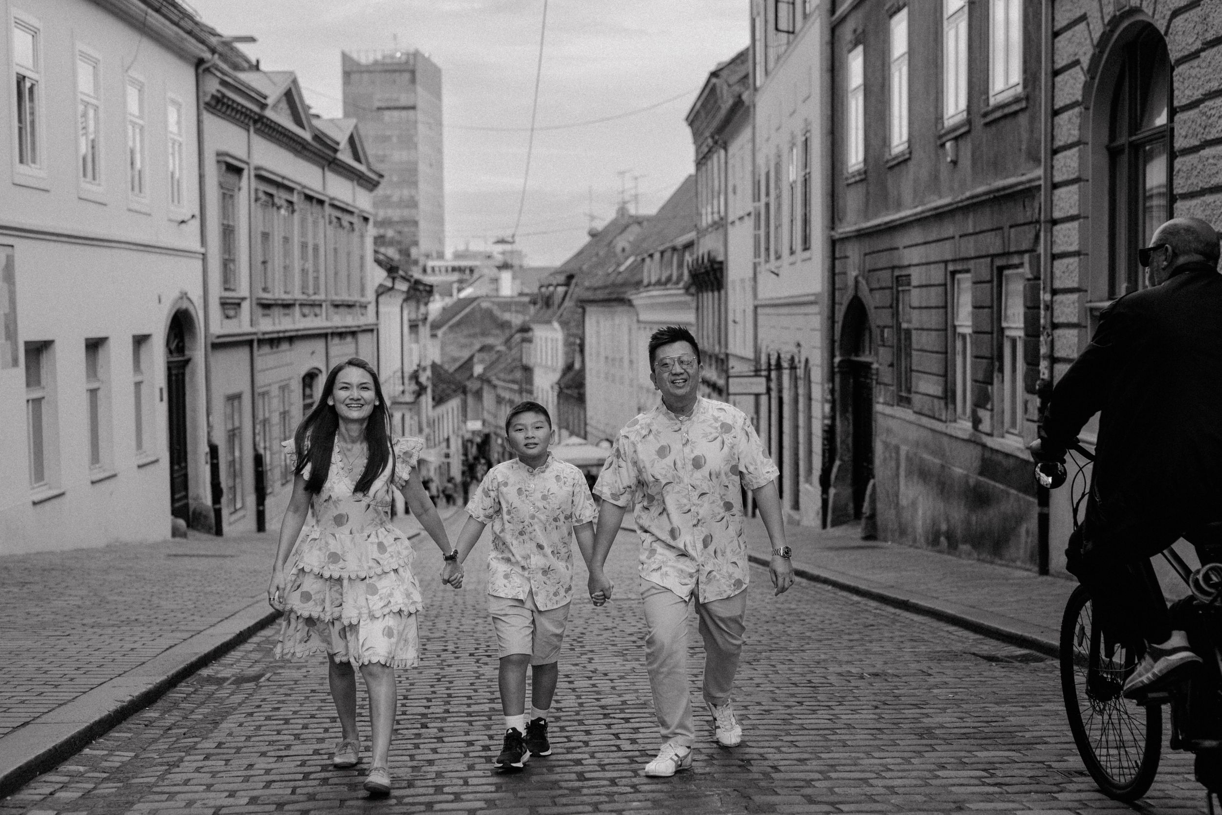 The family strolling down a cobblestone street in Zagreb during their vacation photoshoot.