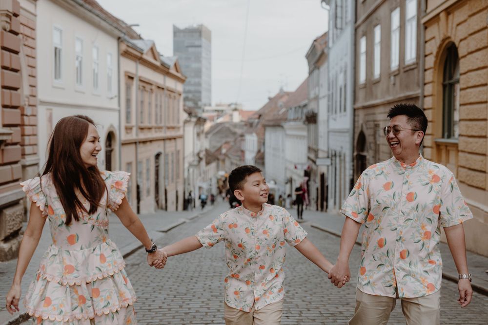 Close-up of the family laughing together as they explore the streets of Zagreb during their vacation.