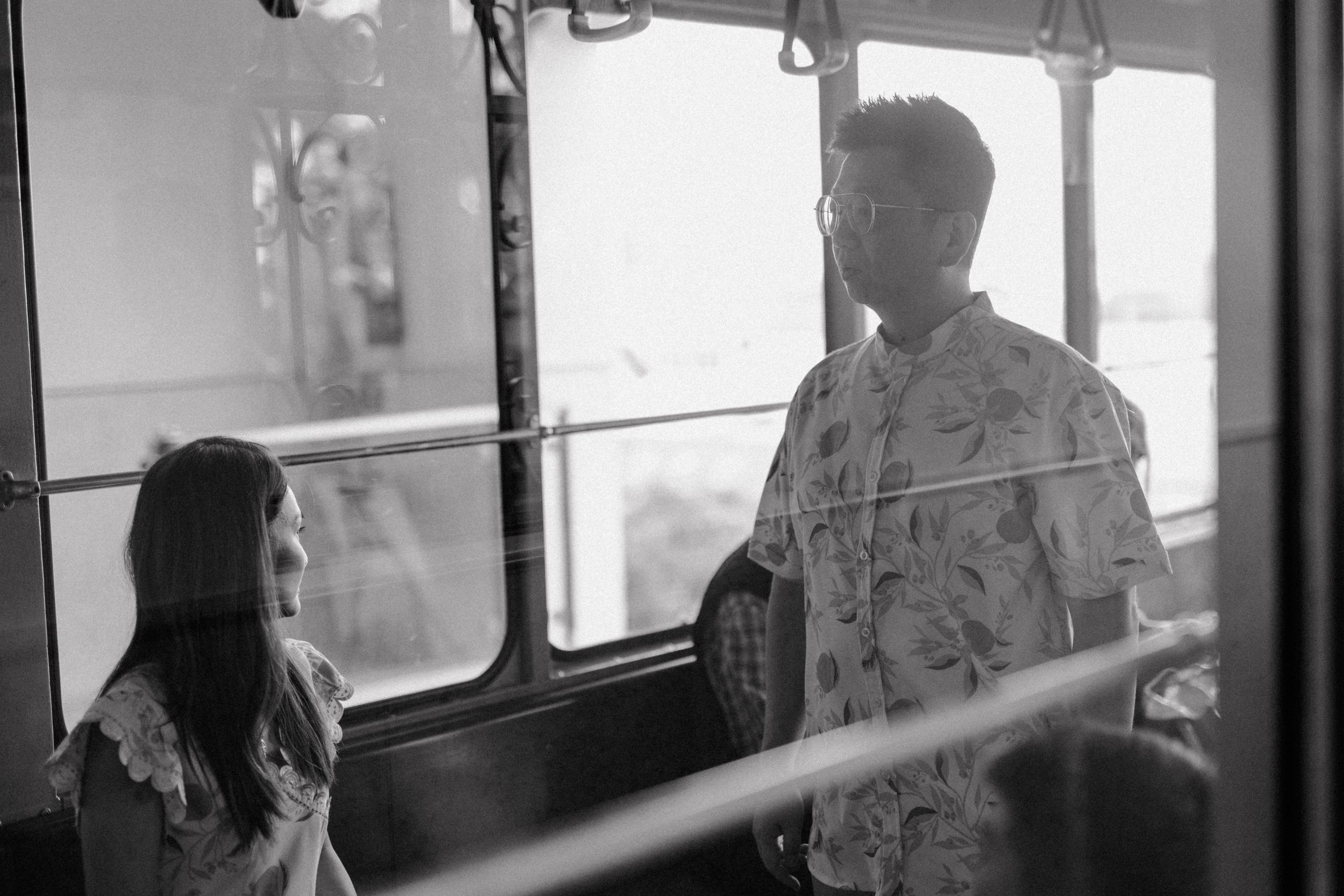 "Artistic black and white photo capturing a poetic moment as the couple enters the funicular.