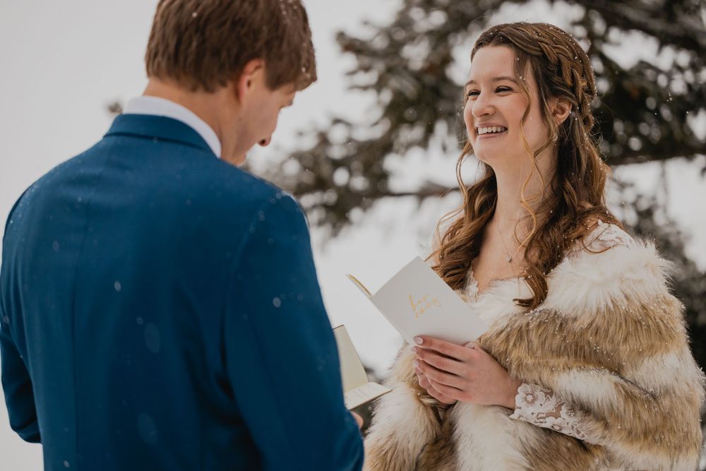 Couple exchanging heartfelt vows against a snowy Breckenridge mountain backdrop