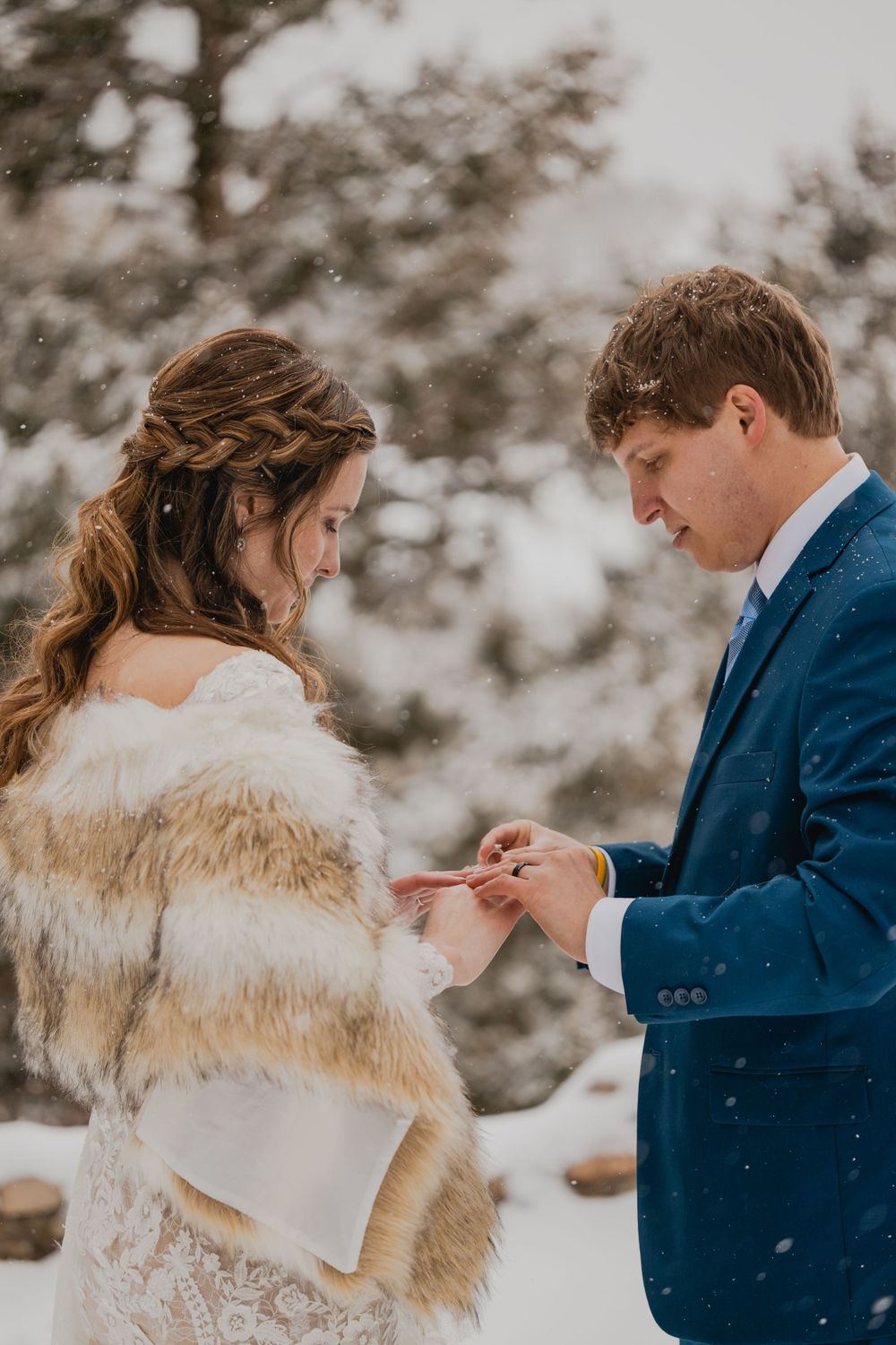 Bride and groom reading vows to each other in a winter wonderland setting