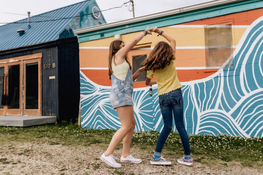 girls spinning around in the vibe district of virginia beach, va