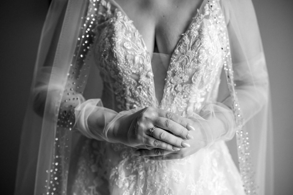 Close-up detail of lace wedding dress bodice in black and white.