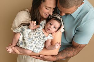 Charlottesville, Virginia Newborn Photographer, family, maternity, baby, parents lovingly cradle their alert newborn daughter.