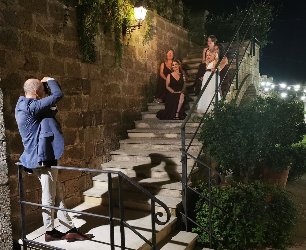 Wedding photographer Alan Harbord photographing bridesmaids on steps of castle garden