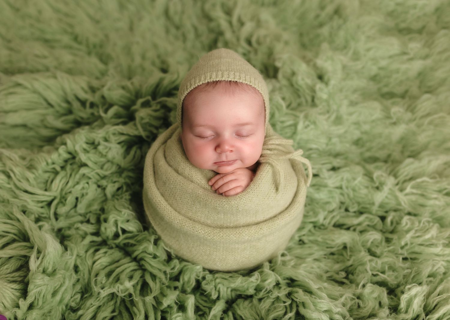 Charlottesville photographer, newborn, family, maternity, baby, newborn girl sleeps wrapped in sages knits  against a sage flokati.