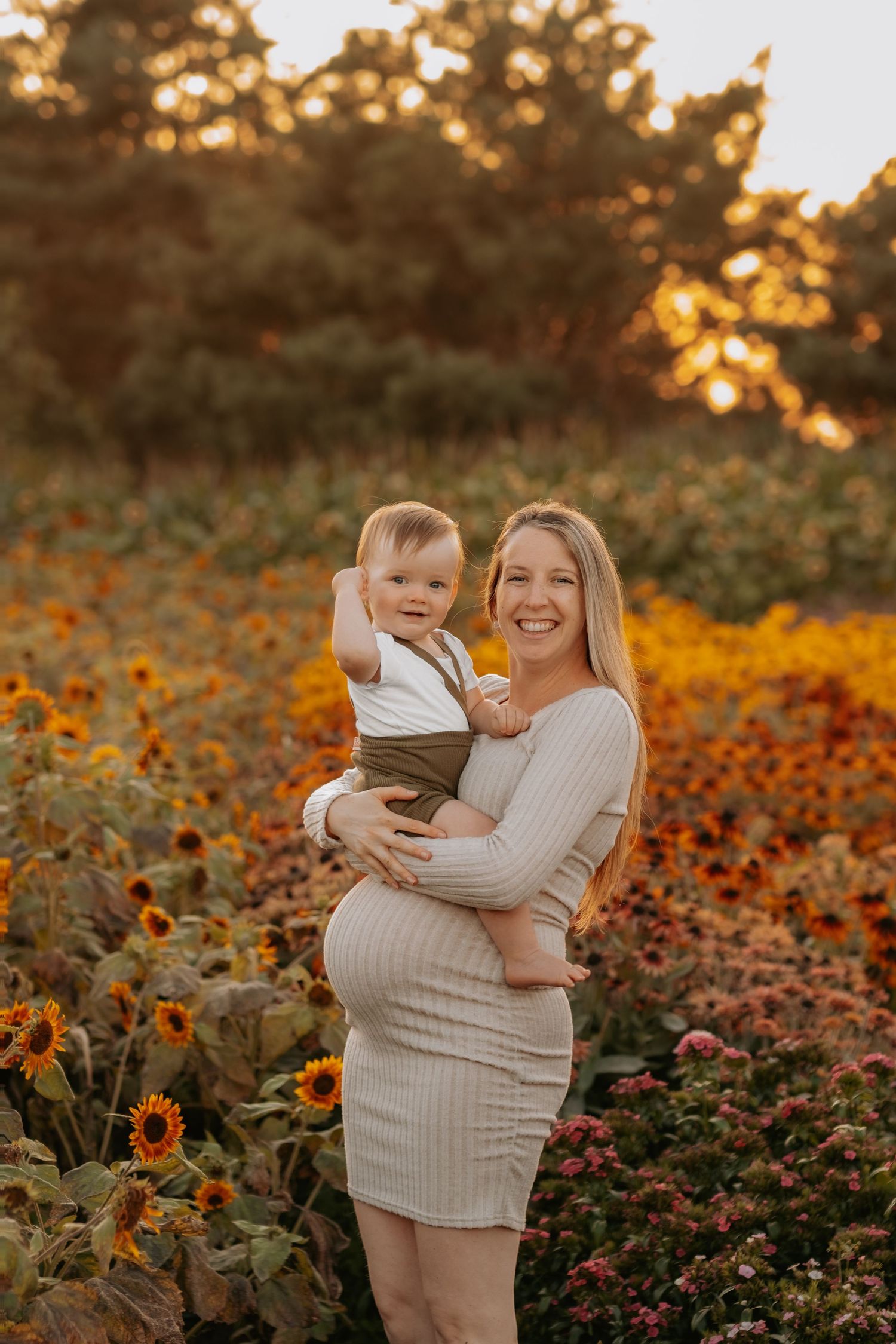 A sunset photo in a field of orange wildflowers and sunflowers during golden hour.