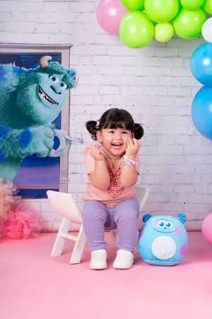 Playful scene with Monsters Inc themed decorations and colorful balloons.