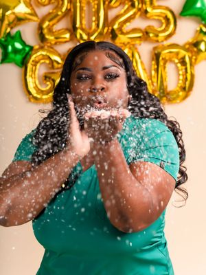 Person in teal dress blows glitter and confetti in celebratory photo sequence.