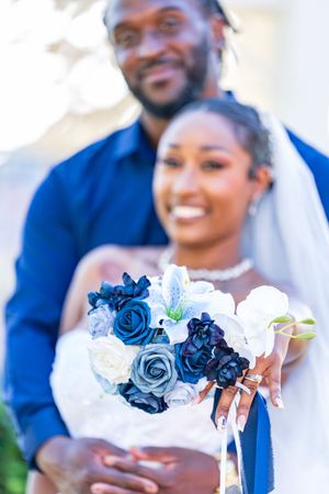 Wedding party detail shots featuring blue and white floral bouquets.