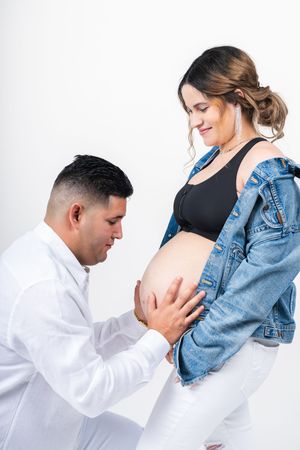 Maternity photo sequence showing couple in denim and white sharing intimate moments.