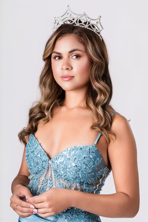 Model wearing a light blue lace bodice poses in multiple glamour shots with a tiara.