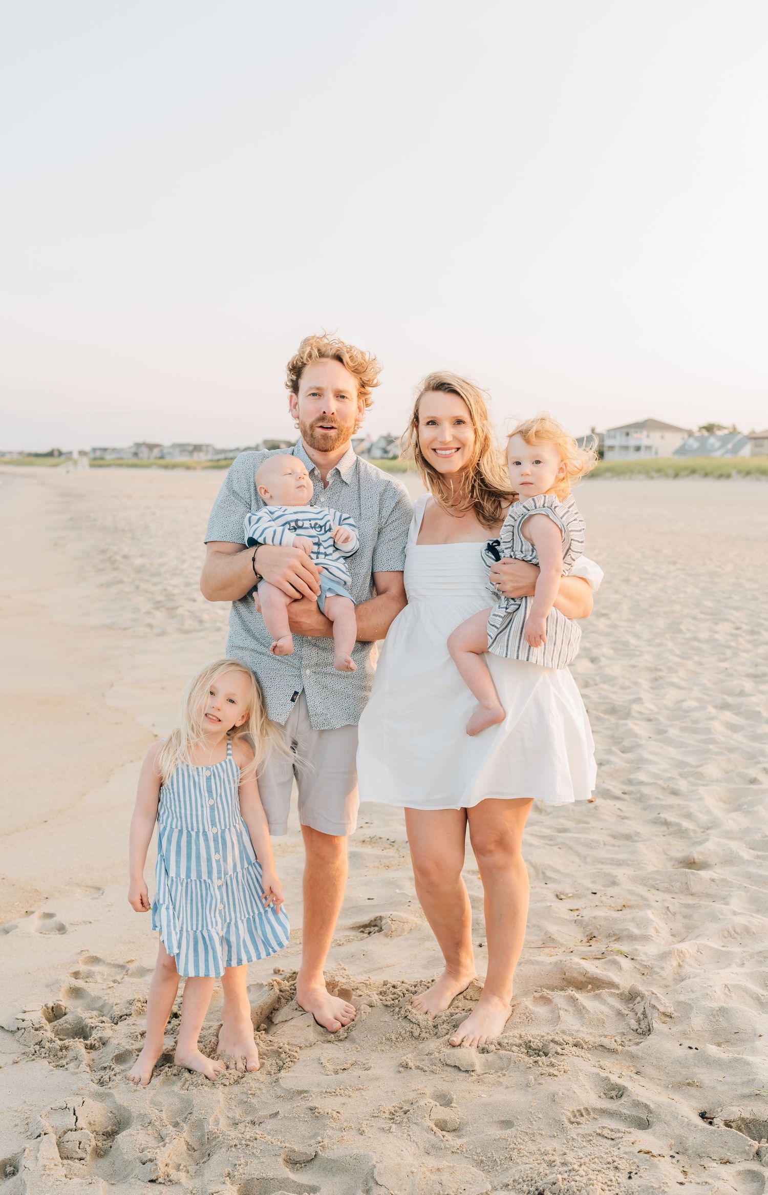 Family photos on sea girt beach in coordinating outfits for summer.