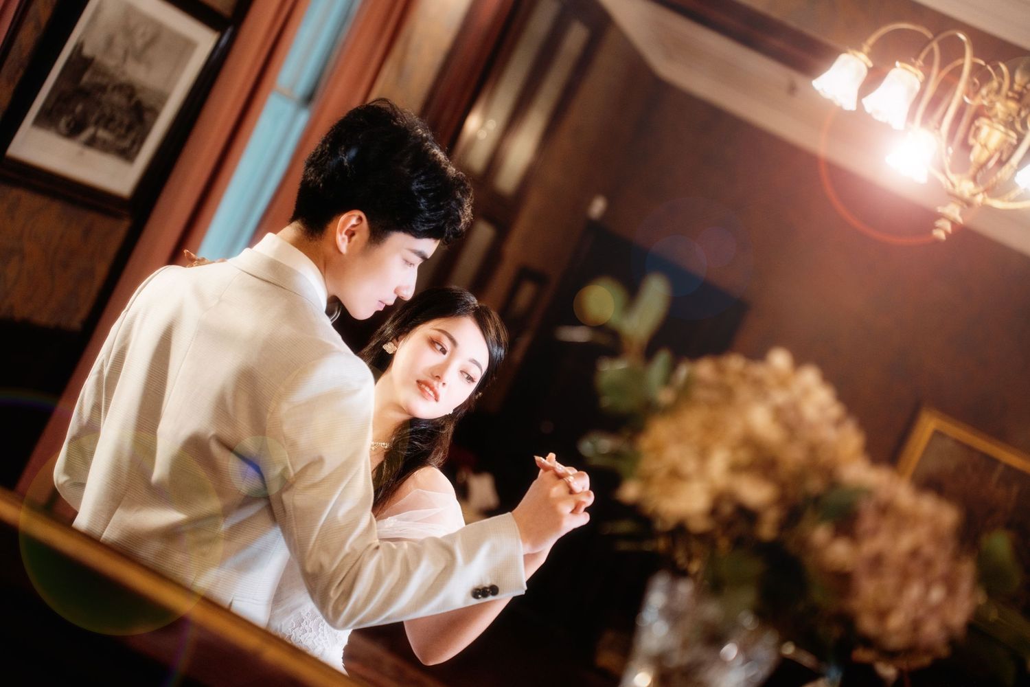 Romantic couple sharing a dance in a warmly lit classic vintage heritage house for Auckland indoor wedding photography.