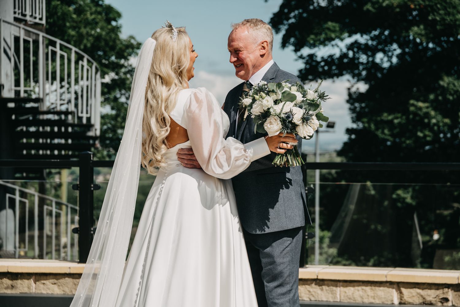 A romantic wedding moment captured from different angles on a sunny day outside a stone building.
