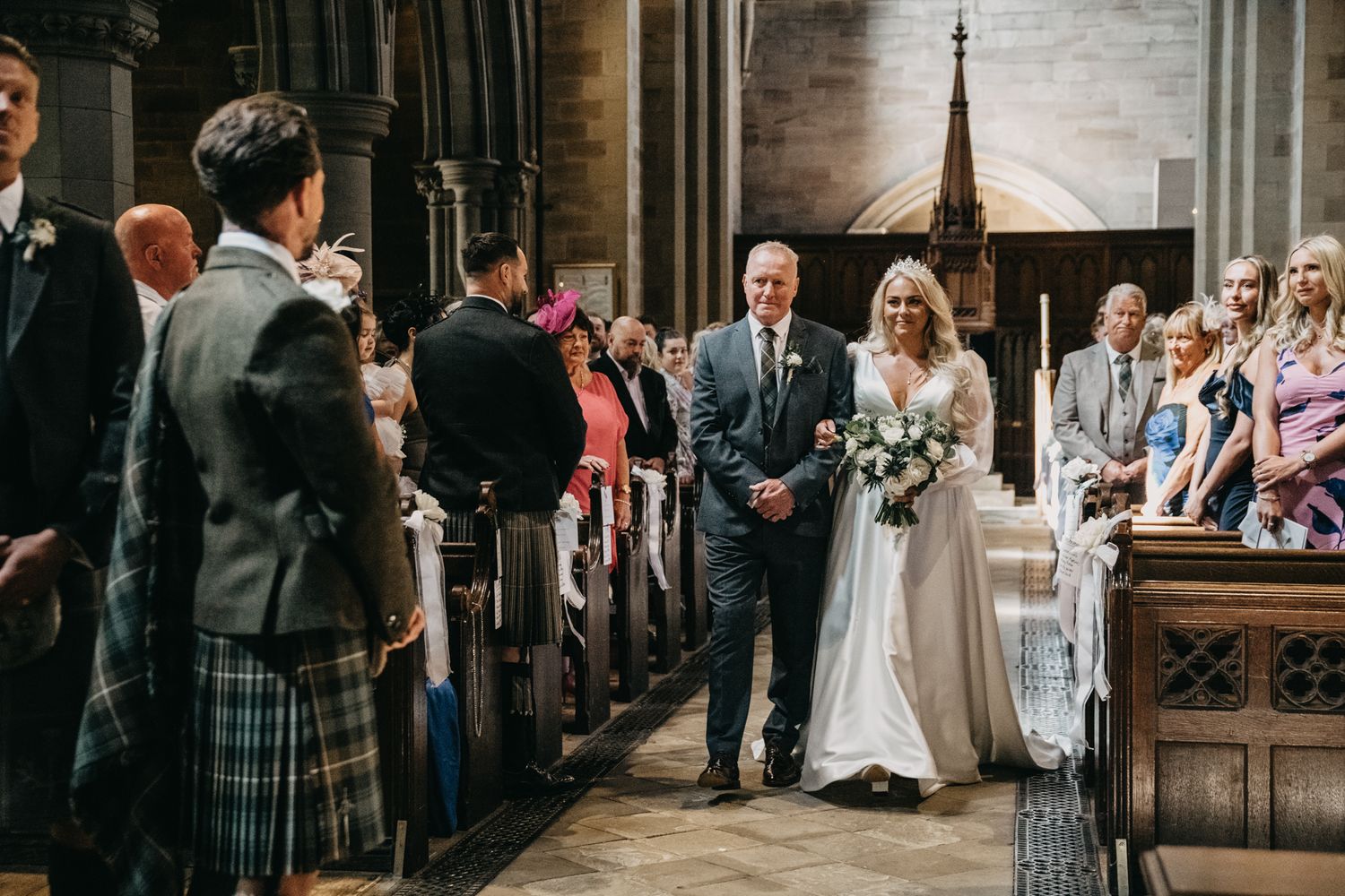 Wedding ceremony inside a grand cathedral with traditional stone architecture and gothic details.