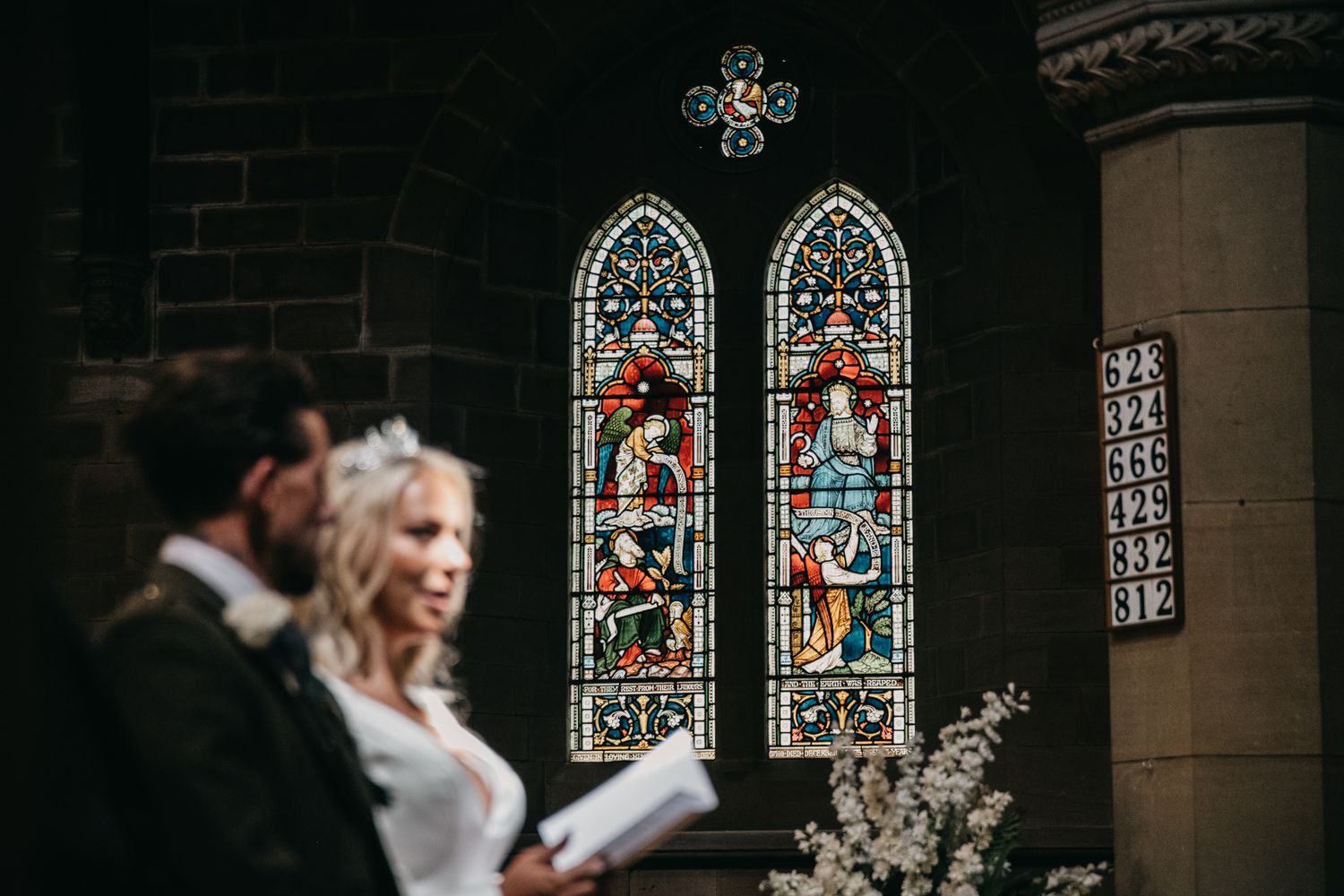 Gothic church interior with colorful stained glass windows and architectural details.