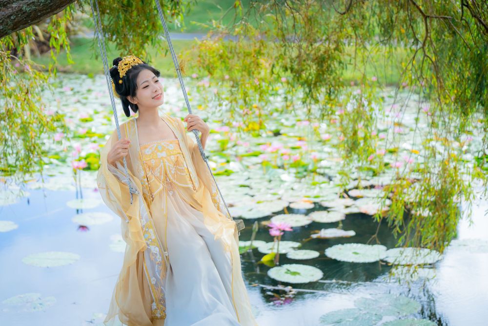 Elegant golden Hanfu portrait by a tranquil water lily lake inspired by Monet's Garden in North Shore, by Imagine Image Studio.