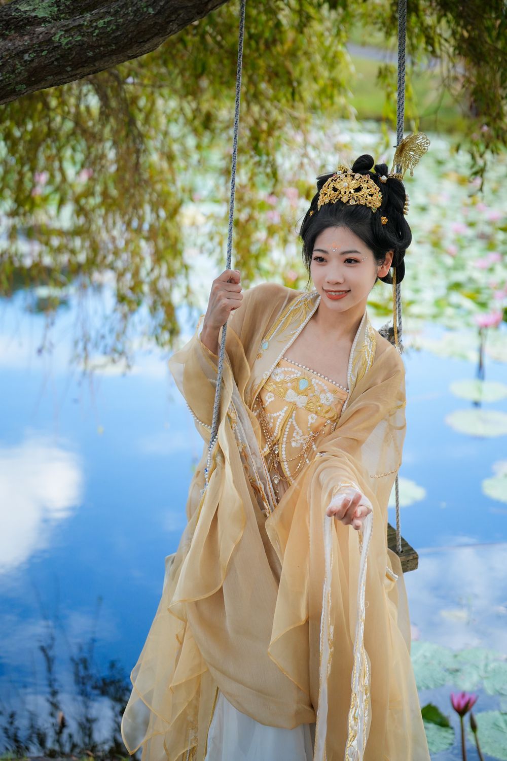 Serene solo portrait in a glowing golden Hanfu by a tranquil North Shore water lily lake, by Auckland photographer Imagine Image Studio.