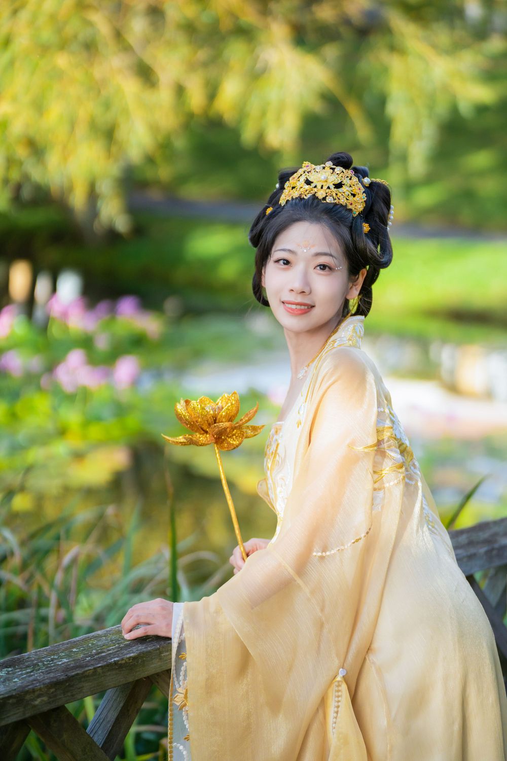 Serene solo portrait in a glowing golden Hanfu by a tranquil North Shore water lily lake, by Auckland photographer Imagine Image Studio.
