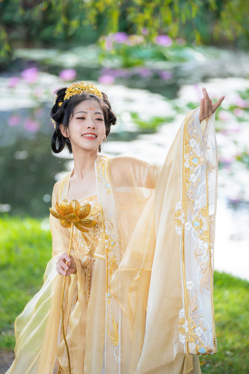 Serene solo portrait in a glowing golden Hanfu by a tranquil North Shore water lily lake, by Auckland photographer Imagine Image Studio.