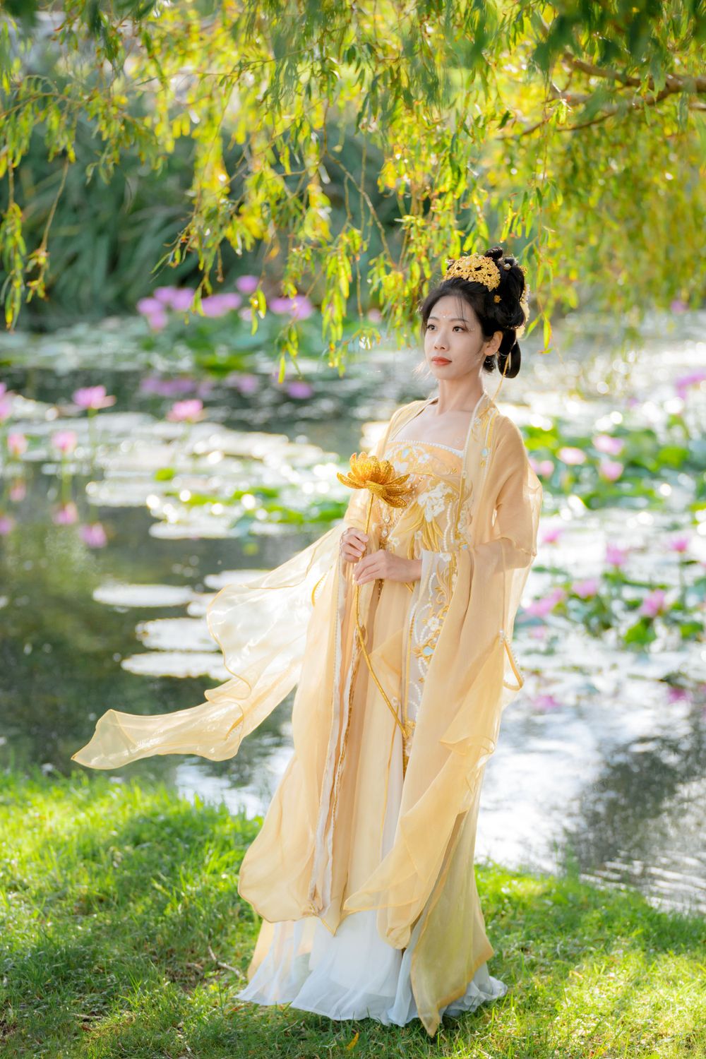Serene solo portrait in a glowing golden Hanfu by a tranquil North Shore water lily lake, by Auckland photographer Imagine Image Studio.