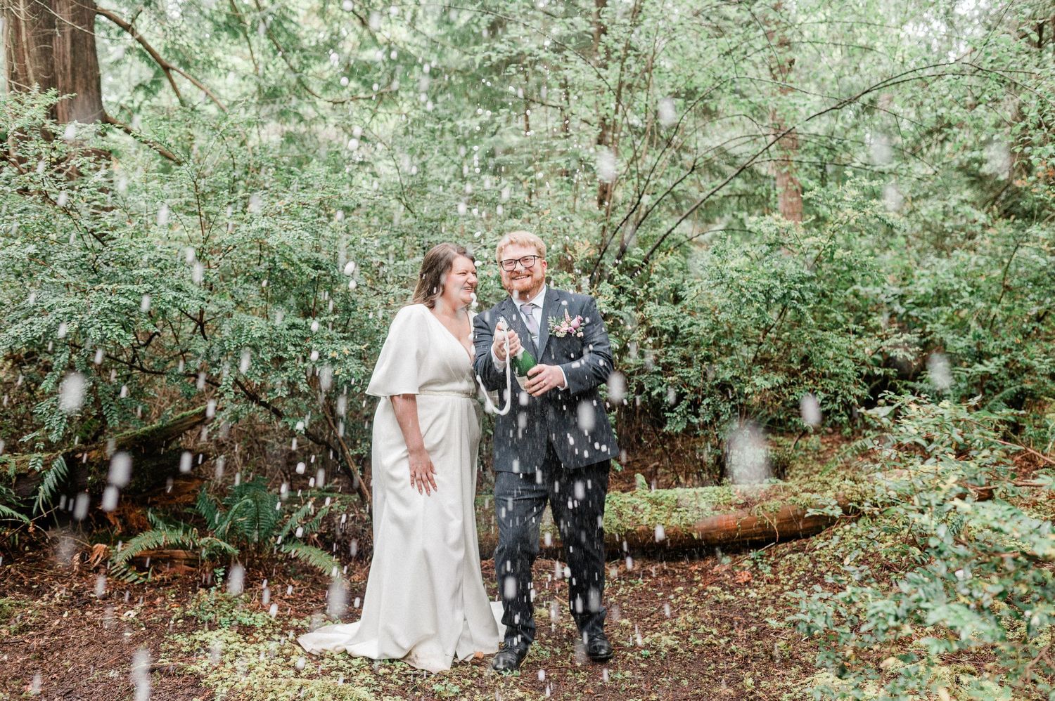bride and groom popping champagne. photo by Tori Shults