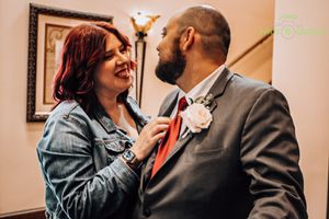 Couple sharing an intimate moment during what appears to be a wedding celebration.