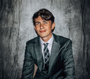 Professional studio portrait series of a person in a grey suit against a textured backdrop.