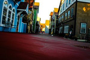 Colorful urban street scene with historic buildings and dramatic evening lighting.