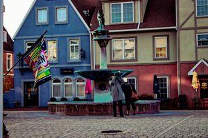 Quaint European village street with cobblestones and traditional architecture.