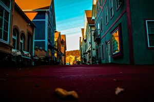 Urban street scene with vibrant orange and blue tones during sunset.