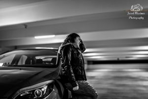 Atmospheric black and white parking garage photoshoot with dramatic lighting.