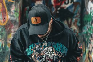 Streetwear fashion series showcasing black hoodie with artistic graphics in urban setting.