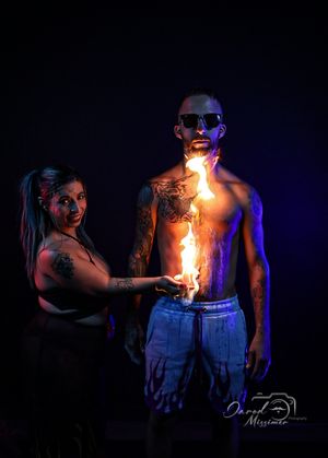 Fire performance art captured in dramatic blue-lit sequence showing flame manipulation.