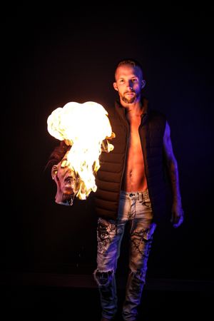 Sequential shots capture fire breathing stunts against dark backdrop.