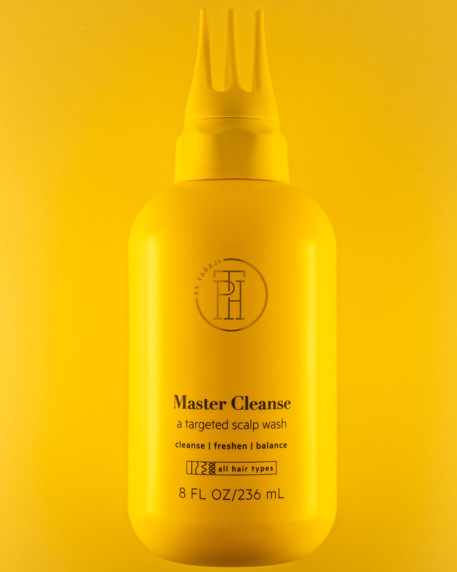 Yellow bottle of Master Cleanse hair product with three-pronged applicator tip against bright yellow background.