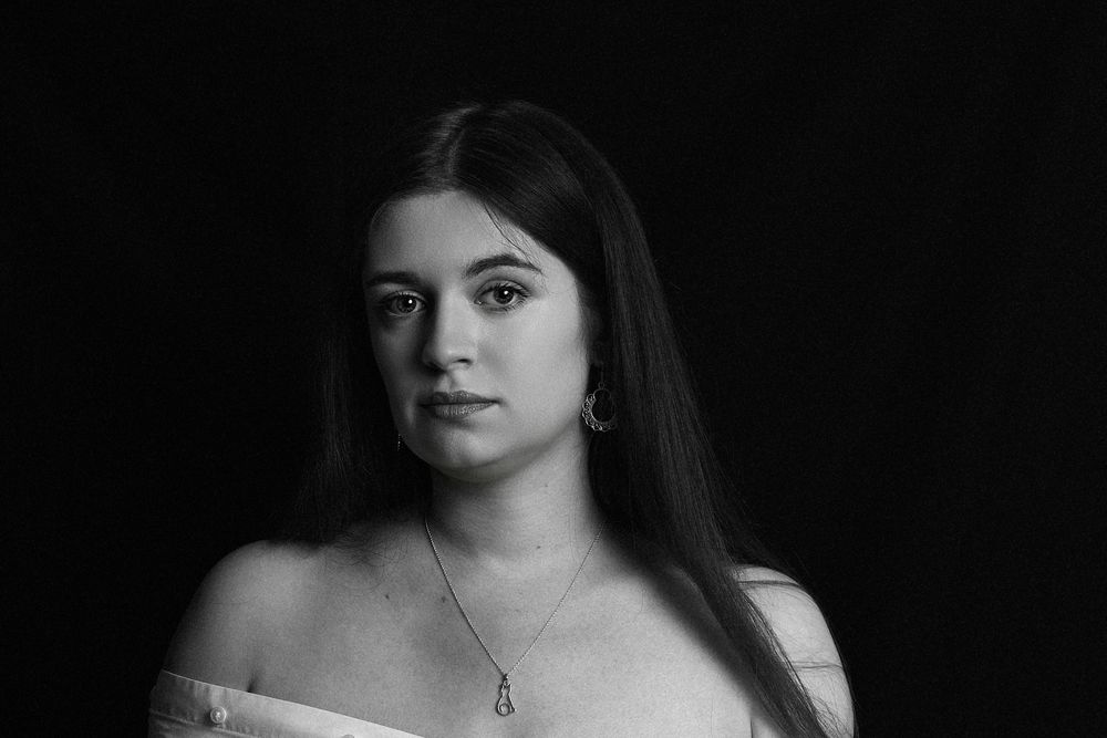 Personal black and white image of a woman, long hair flowing over her shoulders.