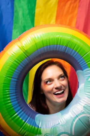 Colorful inflatable rainbow ring creates playful peekaboo portrait series.