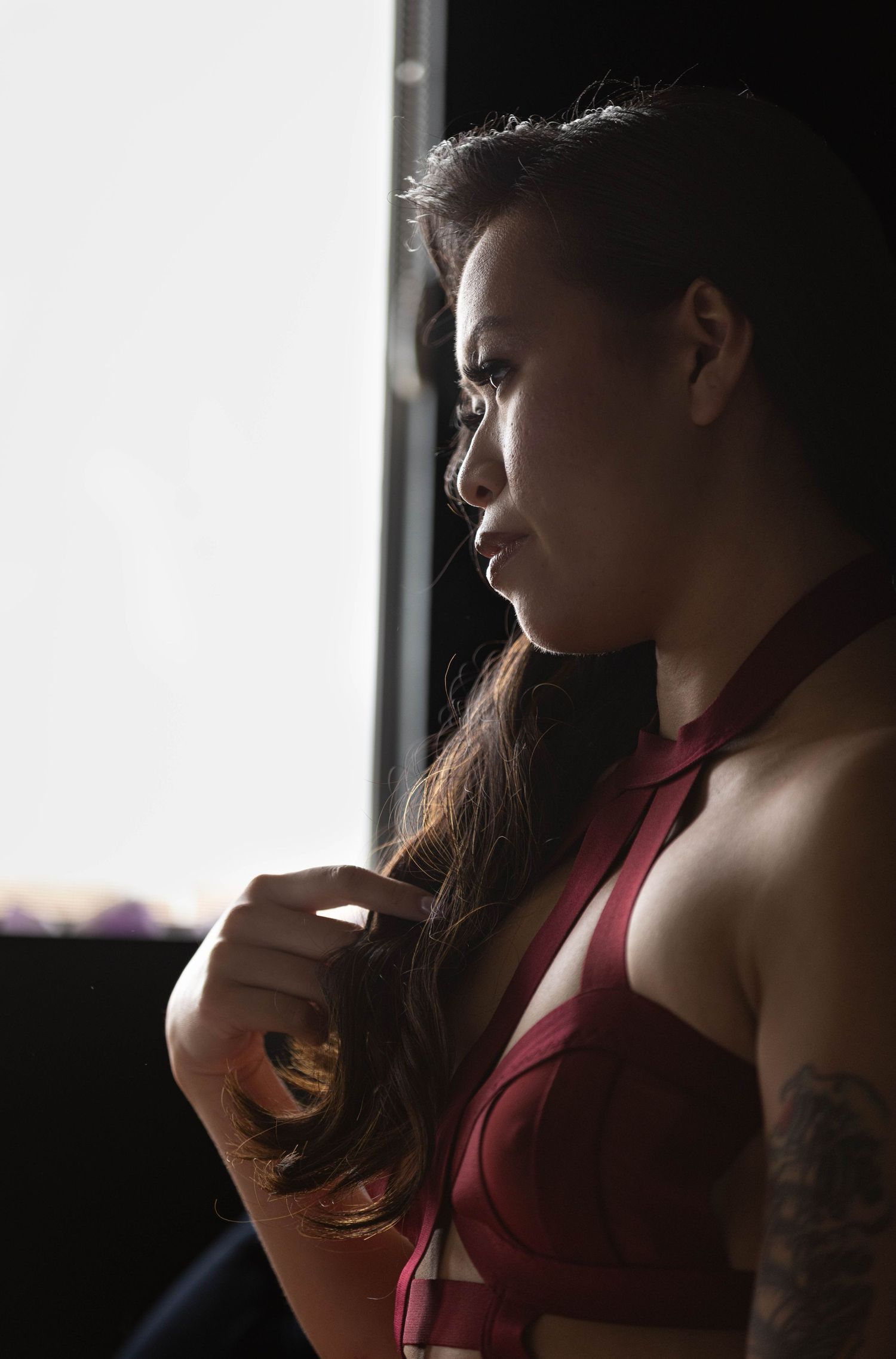 Photograph of woman twirling her hair by Los Angeles boudoir photographer.