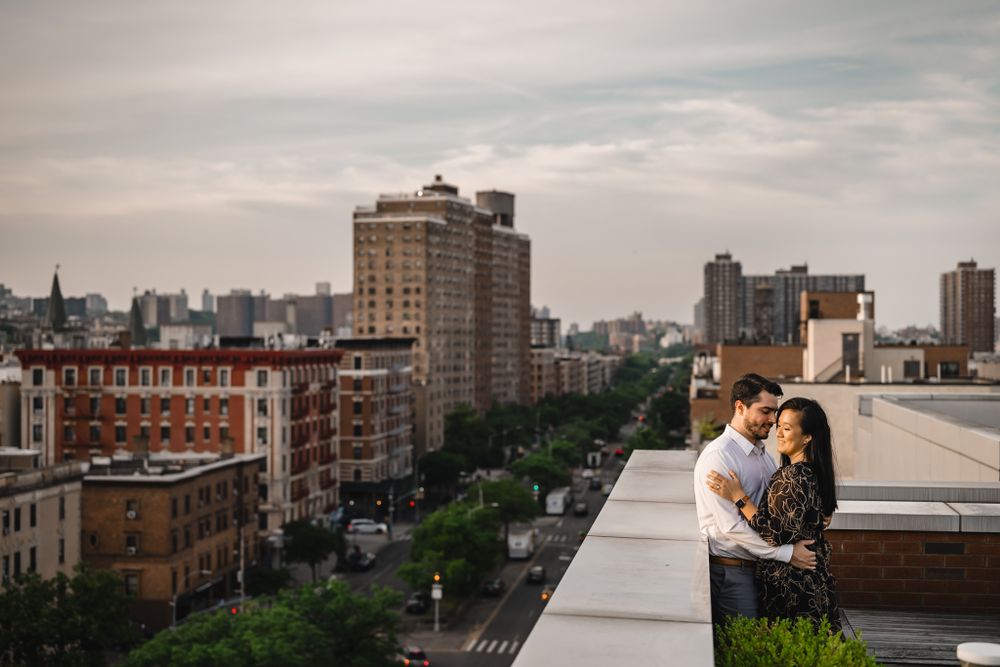 Urban rooftop view of city buildings and architecture under cloudy sky.