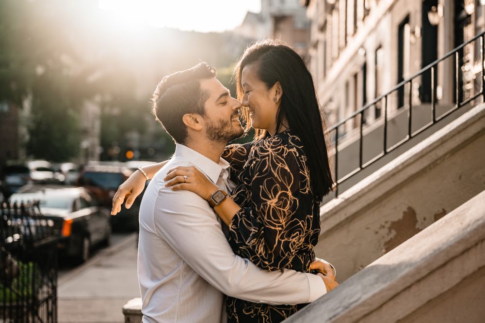 A sweet moment between a couple on urban steps during golden hour.