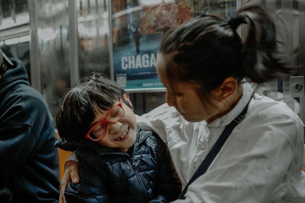 Two people sharing an intimate moment in front of a shop window.