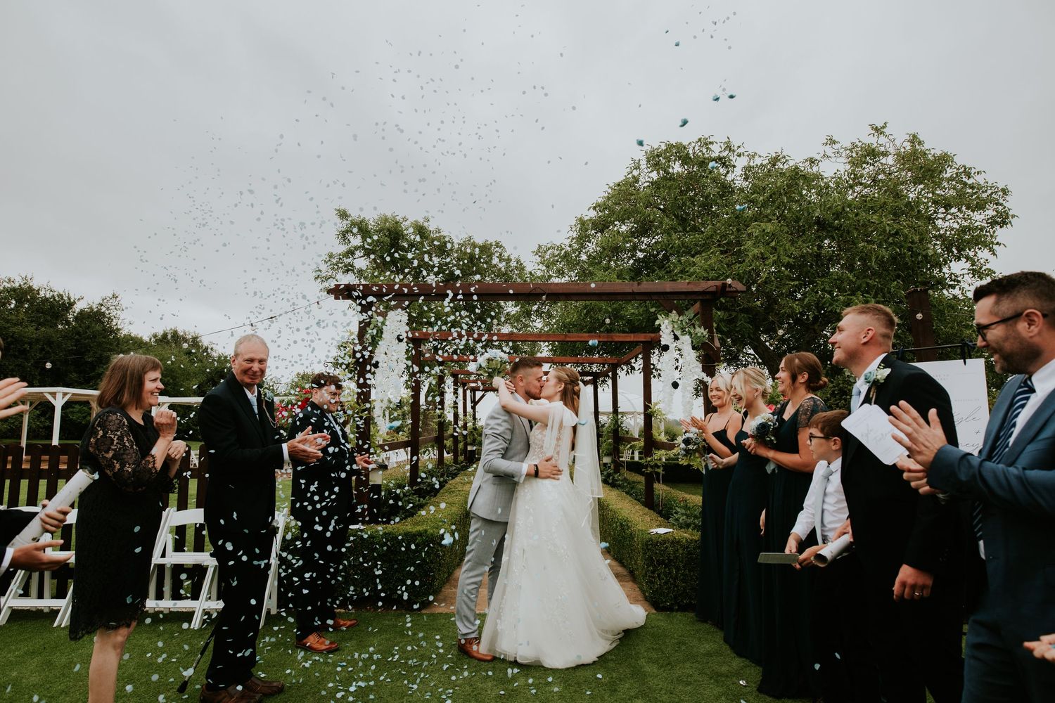 An intimate indoor wedding ceremony in front of a bright glass conservatory window. The Landmark London