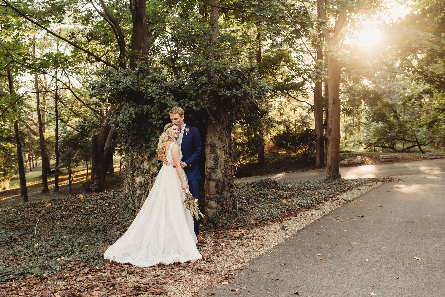Sunset wedding portrait of couple in wooded setting with golden light filtering through trees. Pittsburgh wedding Photographer